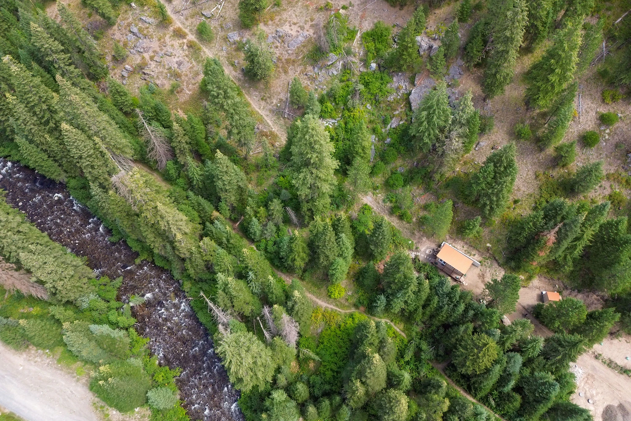Aerial view of Goose Creek, forest trails, and the cottage at the retreat