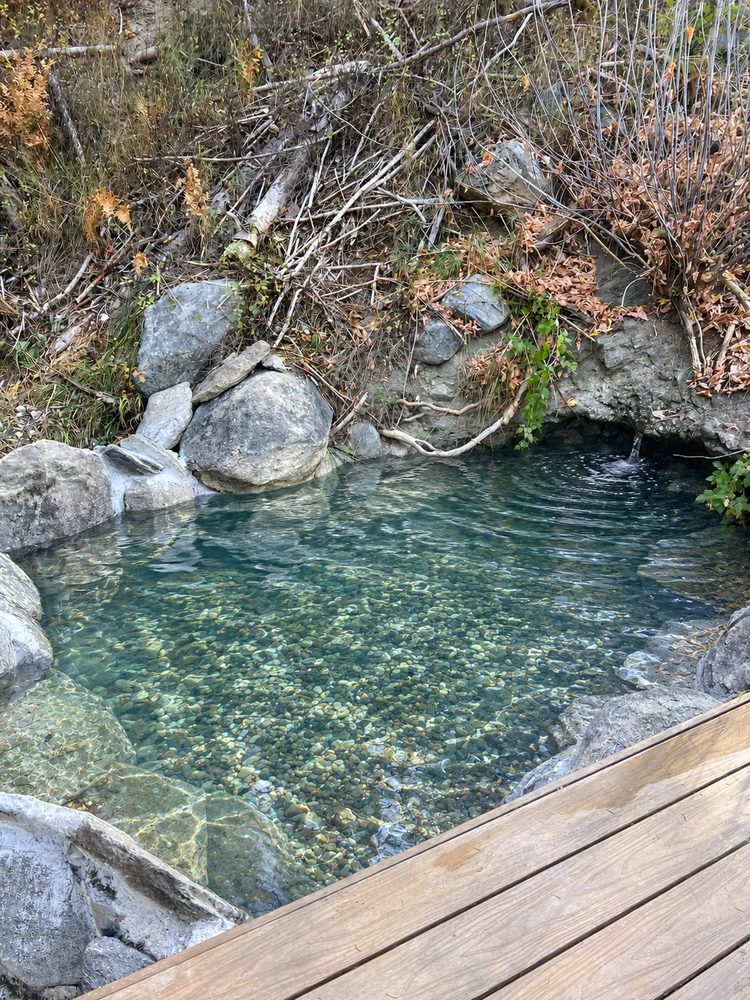 Nest Pool #3 — a clear pebble-bottomed pool next to a deck